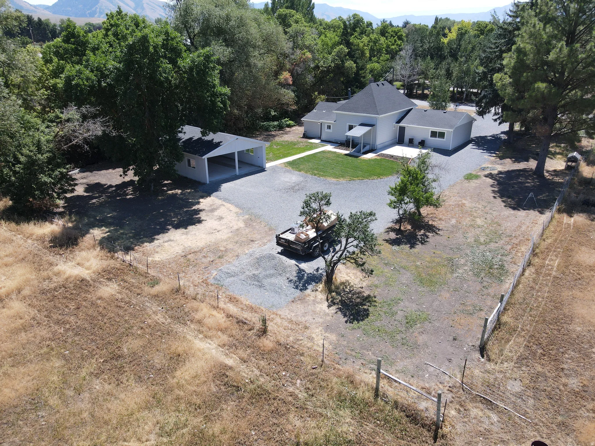 Single-story residence featuring a gray exterior and a dark shingled roof