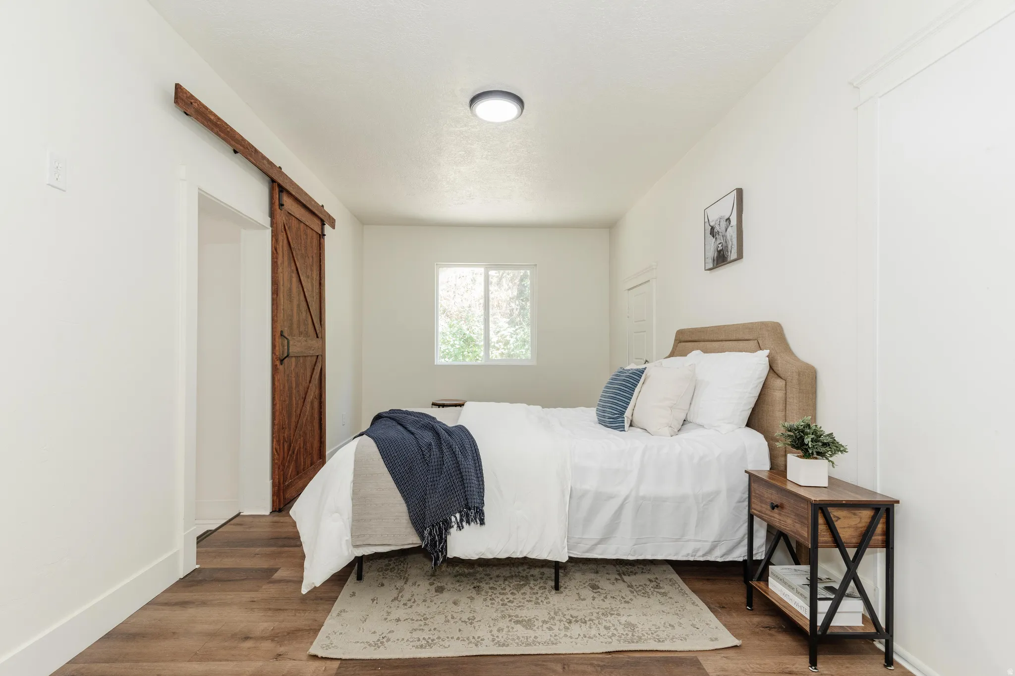 Wood-finish flooring throughout, complemented by a white wall palette
