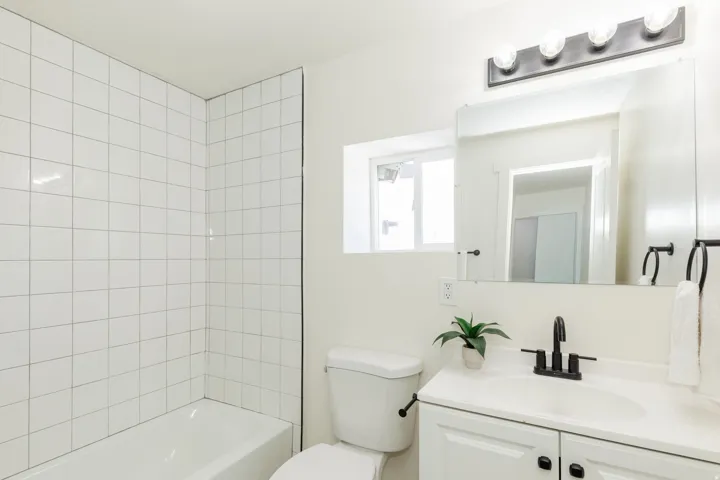 White subway tile shower surround with a built-in tub