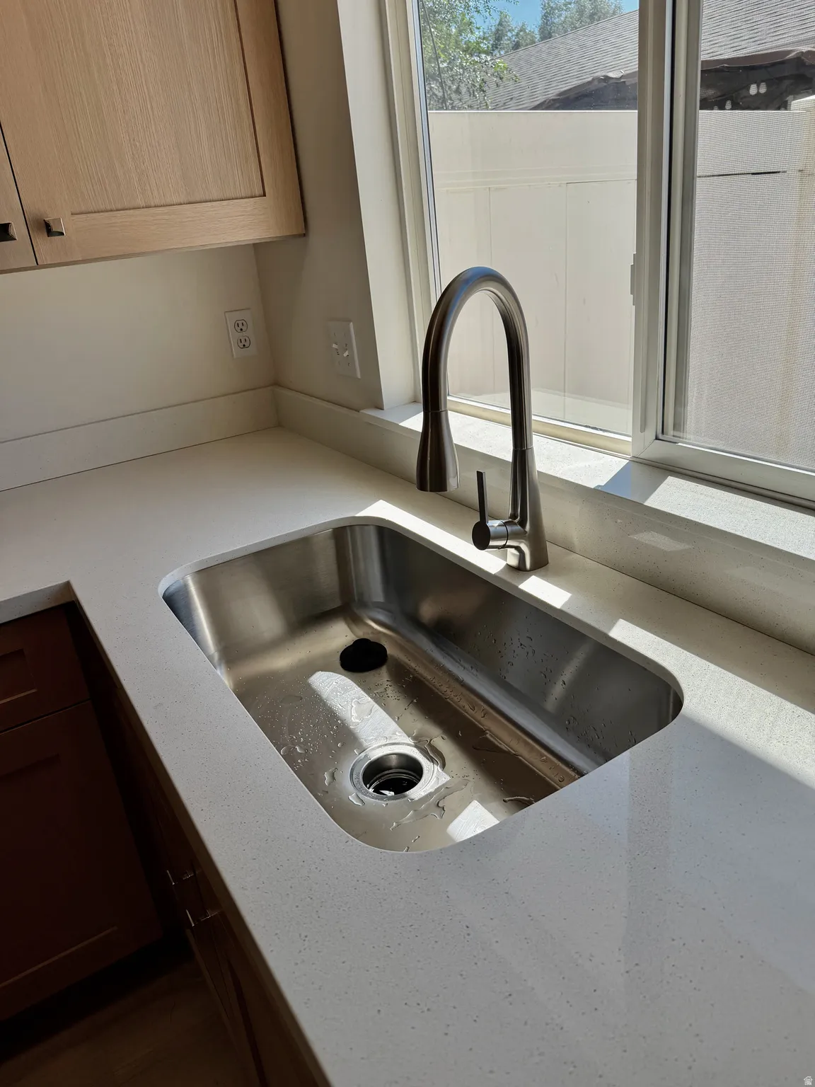 Integrated stainless steel sink with a high-arc brushed nickel faucet