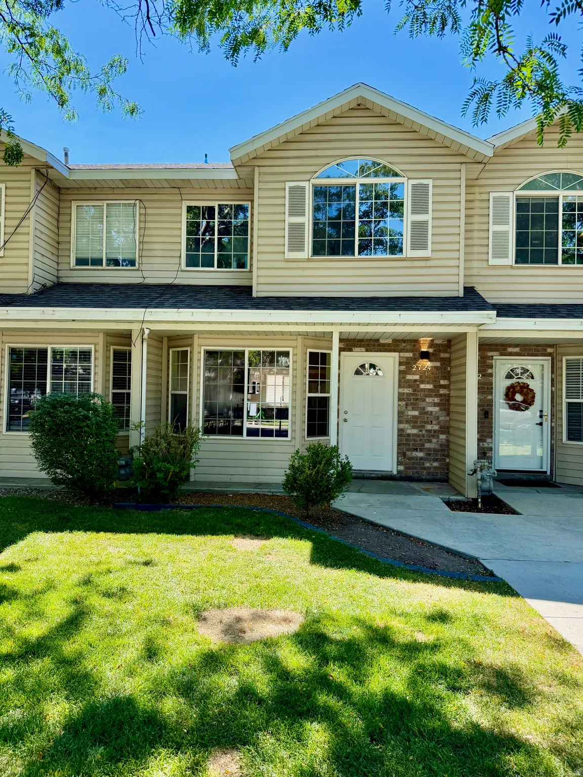 Two-story facade featuring beige siding with white trim