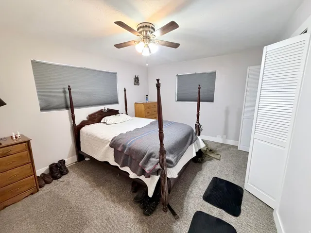 Bedroom featuring light carpet and a ceiling fan