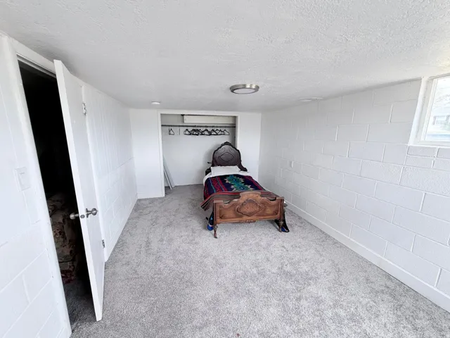 Carpeted bedroom with a textured ceiling
