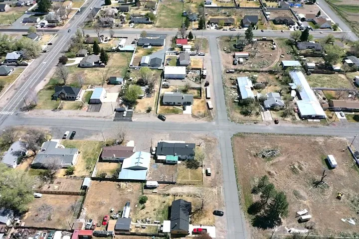 Aerial view of property's location with nearby suburban area