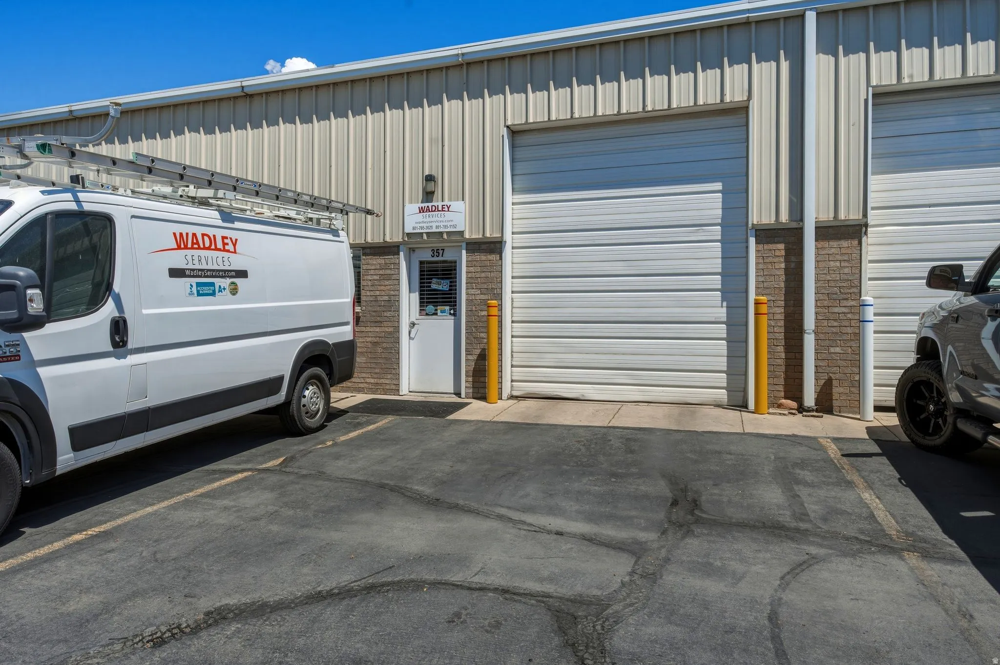 Industrial building exterior featuring corrugated metal siding and brick accents