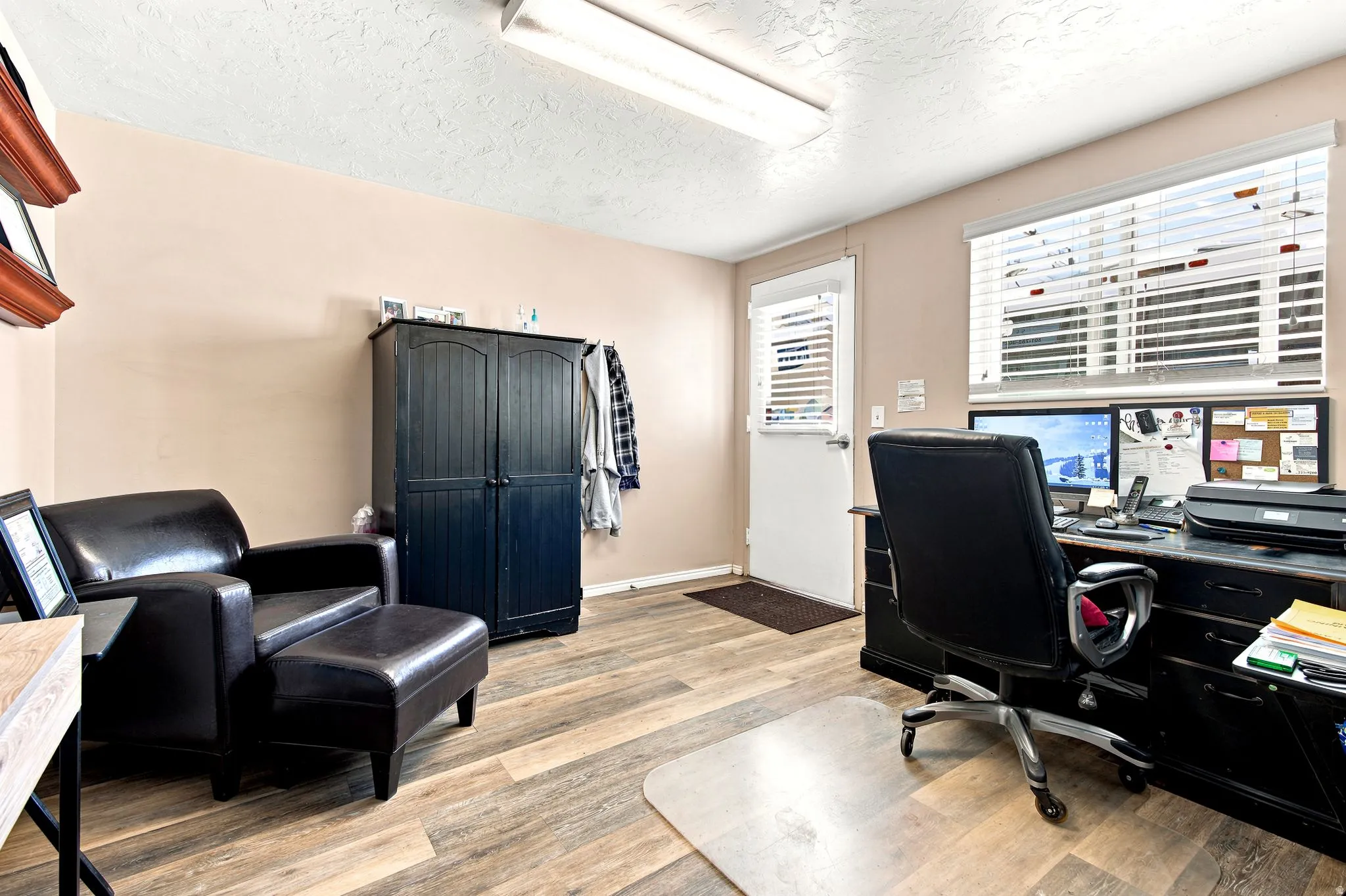 Versatile room featuring wood-finish flooring and neutral wall tones