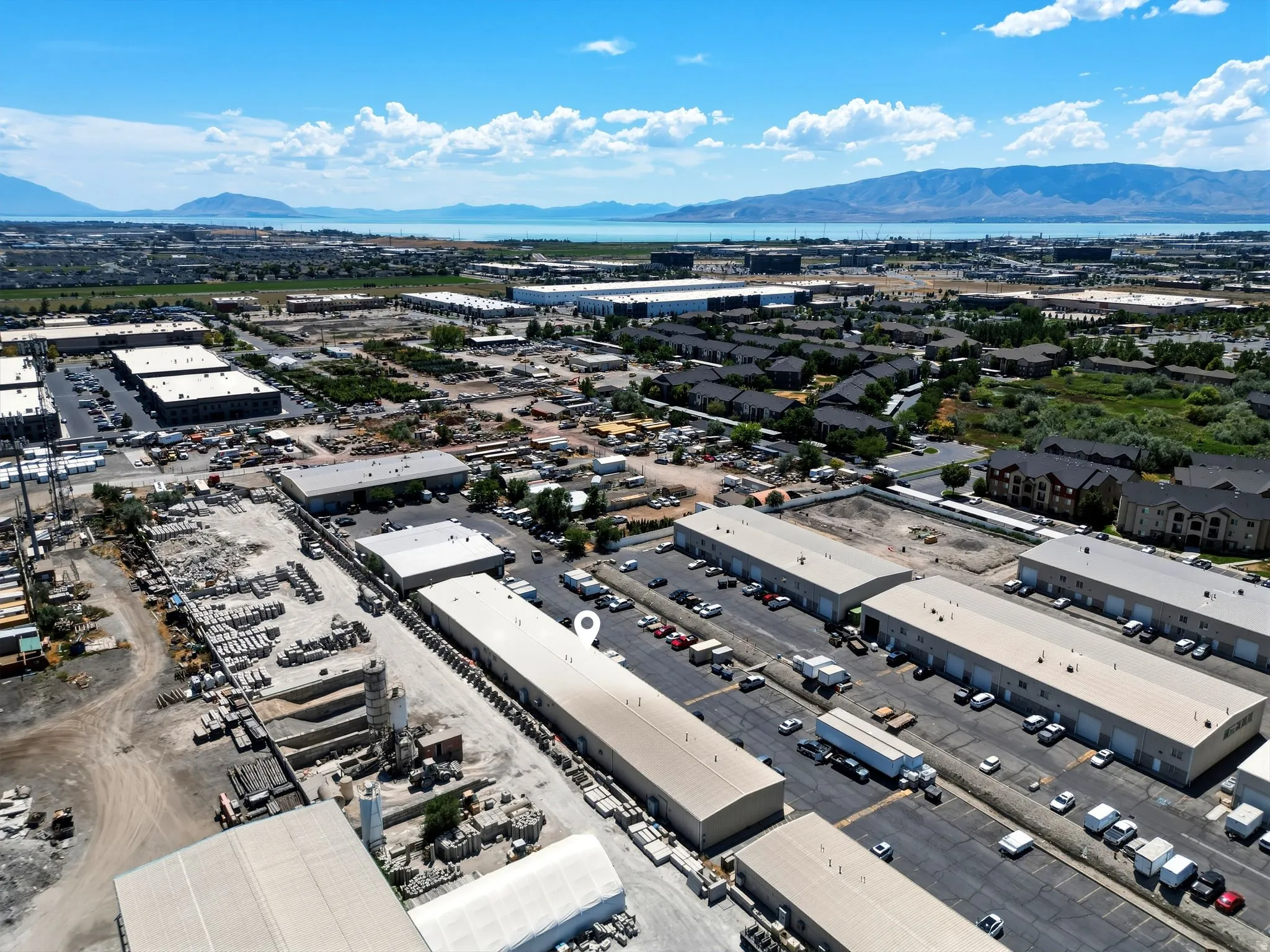 Expansive aerial landscape featuring a large body of water and distant mountains