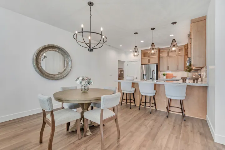 Open-concept dining and kitchen space featuring wood-finish flooring