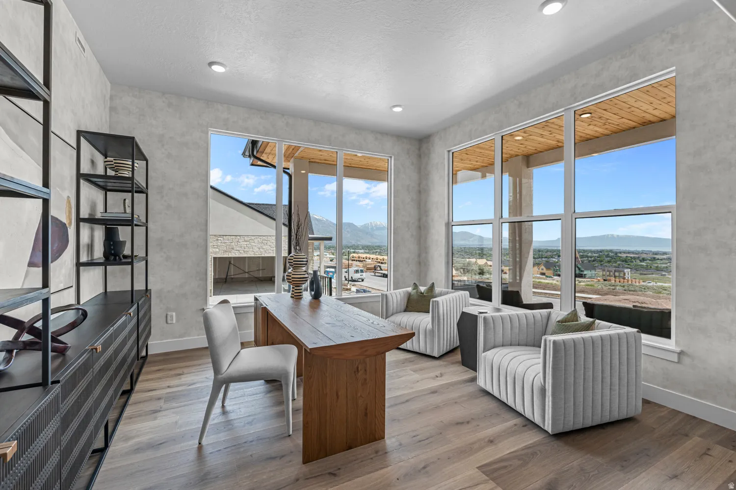 Spacious room featuring multiple large windows offering expansive mountain and landscape scenery