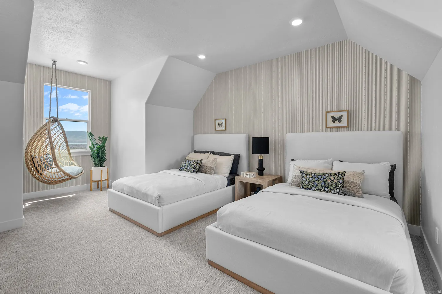 Vaulted ceiling bedroom featuring plush carpeting, vertical stripe accent wall, and recessed lighting