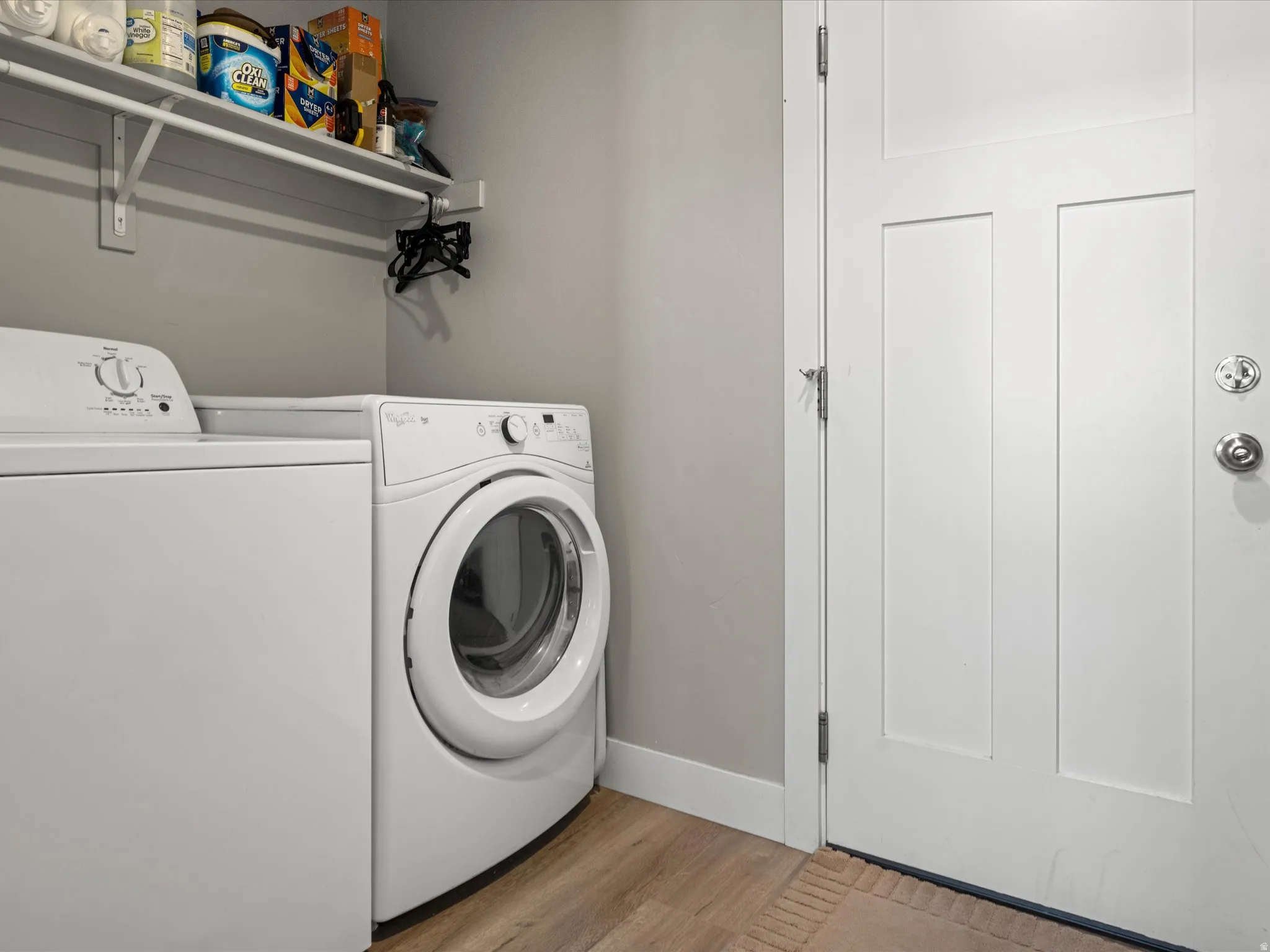 Dedicated laundry area featuring a white top-load washing machine and front-load dryer
