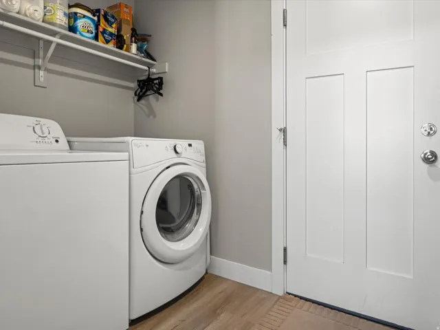 Dedicated laundry area featuring a white top-load washing machine and front-load dryer
