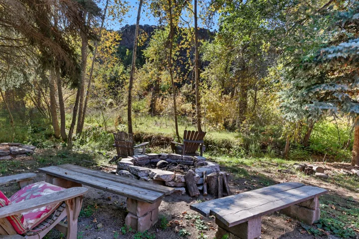 Stone-built fire pit surrounded by a natural landscape