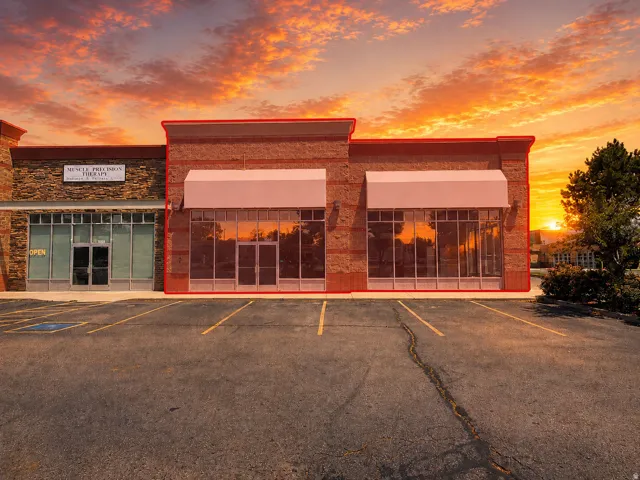 Commercial storefront with brick facade and expansive display windows