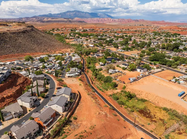 Aerial perspective showcasing a residential area with diverse housing styles, surrounded by natural desert landscapes