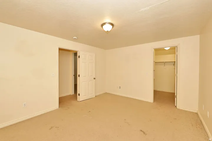Neutral-toned walls complement the carpeted flooring