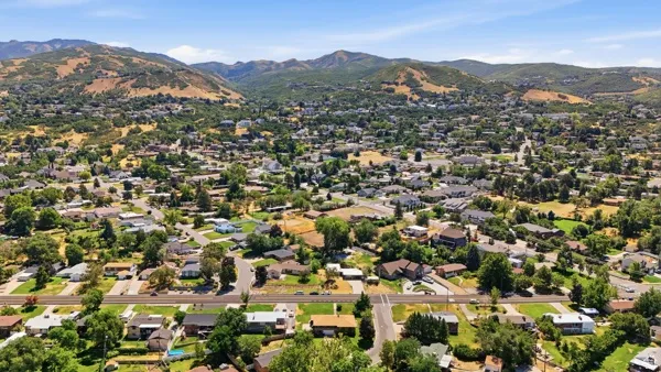 Expansive neighborhood setting featuring numerous residential properties and mature trees