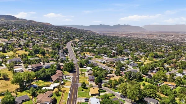 Expansive residential area featuring established homes, mature trees, and a clear roadway