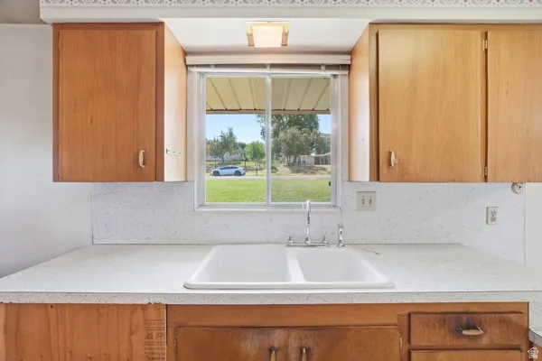 Double basin sink with chrome faucet, set within a light-colored countertop