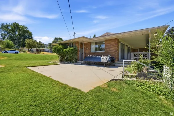 Expansive grassy yard with concrete patio
