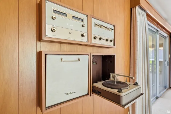 Integrated audio system with wood paneling, featuring a built-in turntable and control units