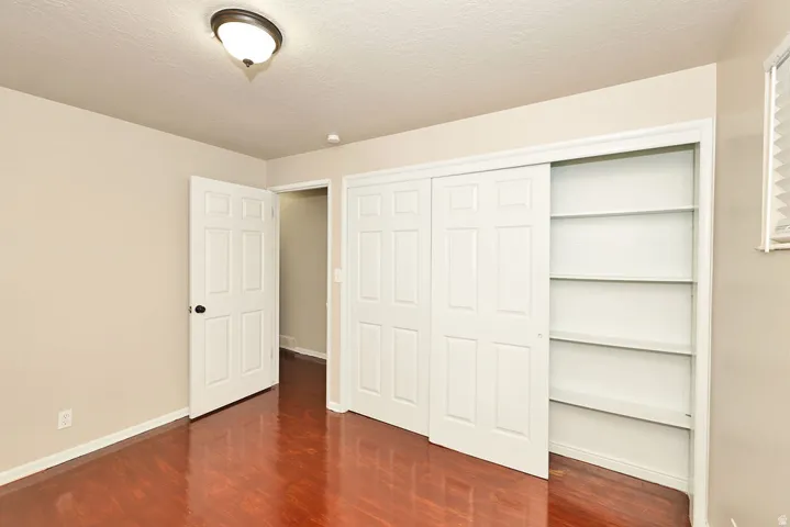 Warm wood-finish flooring complements the neutral wall tones