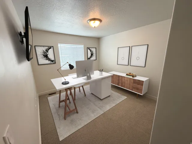 Carpeted room with a ceiling-mounted light fixture
