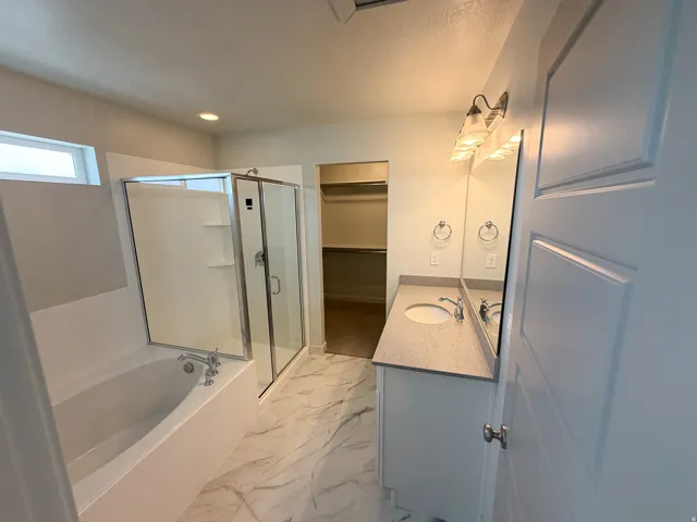 Contemporary bathroom featuring a separate soaking tub and glass-enclosed shower