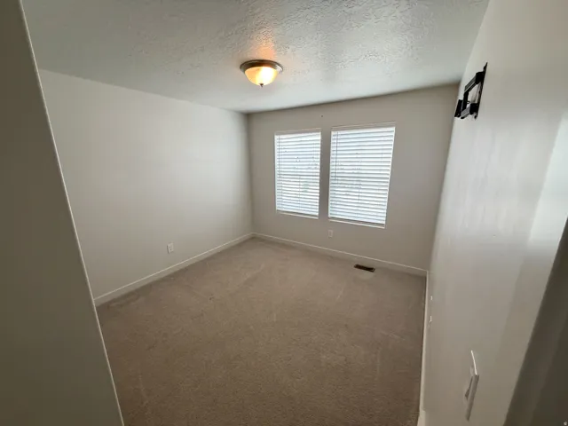 Neutral tone wall paint with two windows featuring horizontal blinds