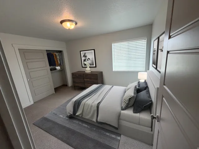 Bedroom featuring a ceiling-mounted light fixture and soft carpet flooring