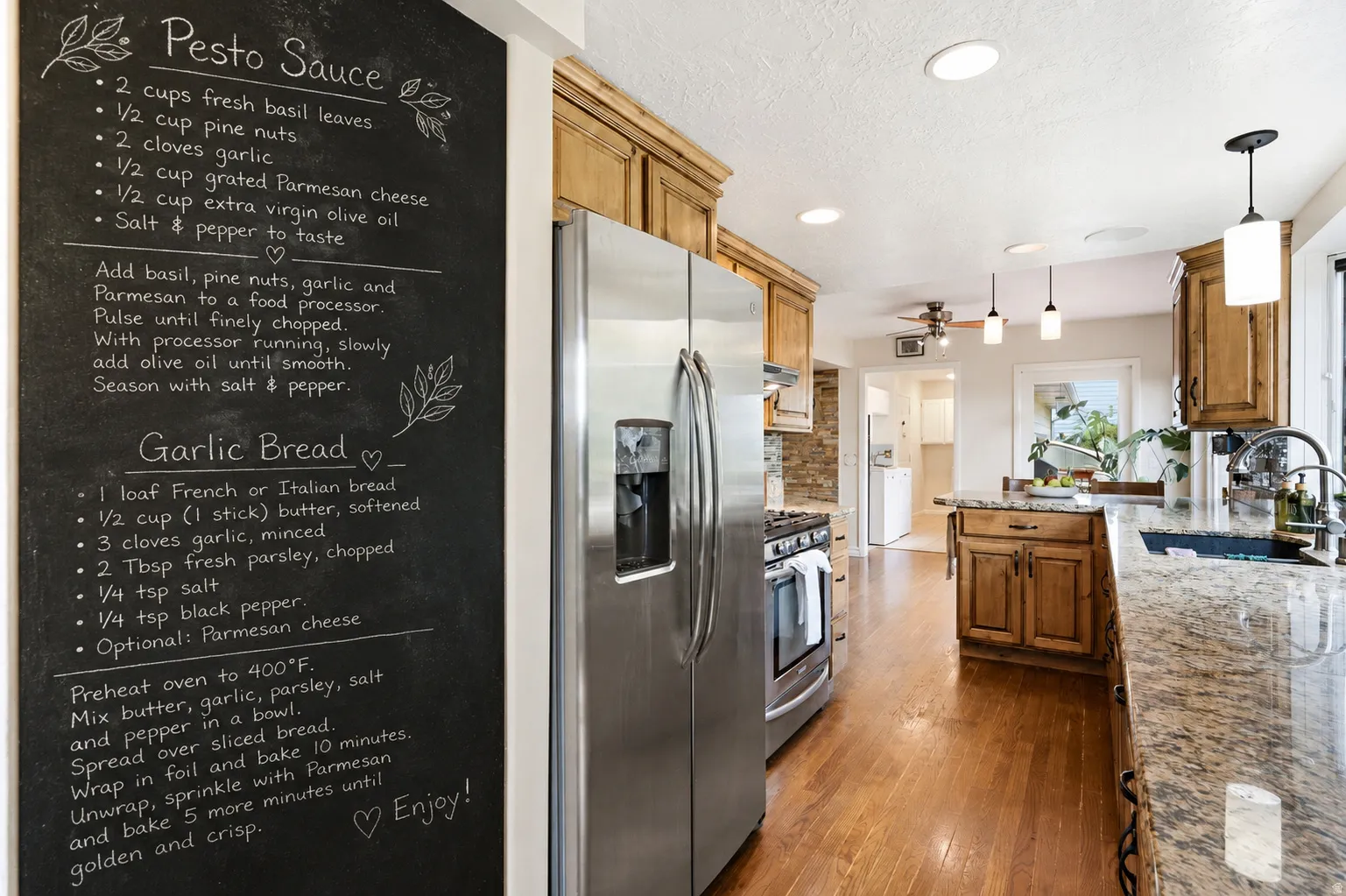 Kitchen featuring wood-finish flooring, stainless steel appliances, granite countertops, wood cabinetry, and recessed lighting