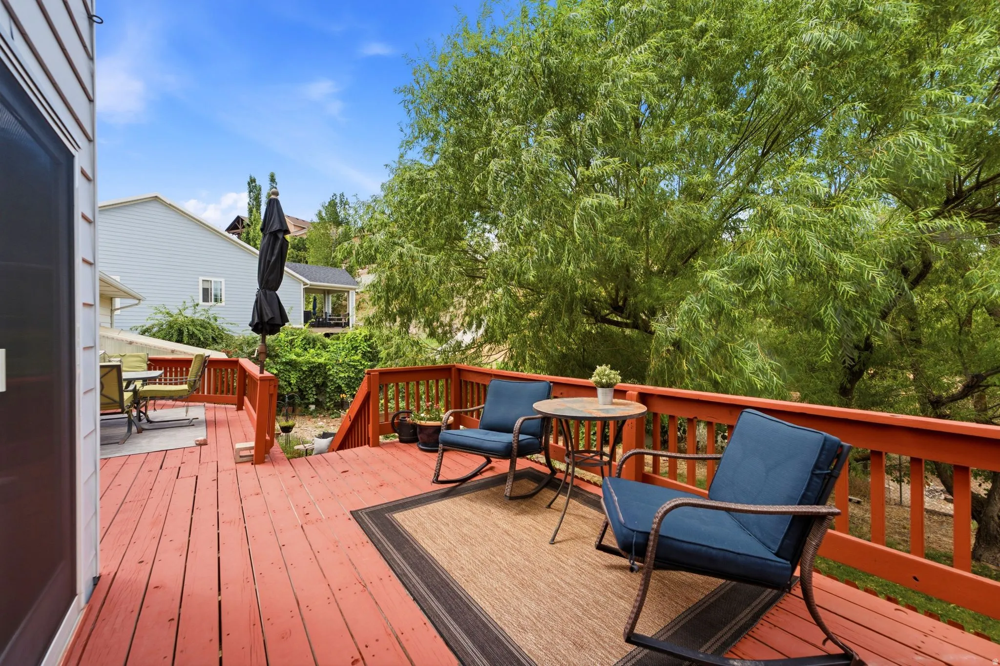 Multi-level wood deck featuring a rich red finish and slatted railings