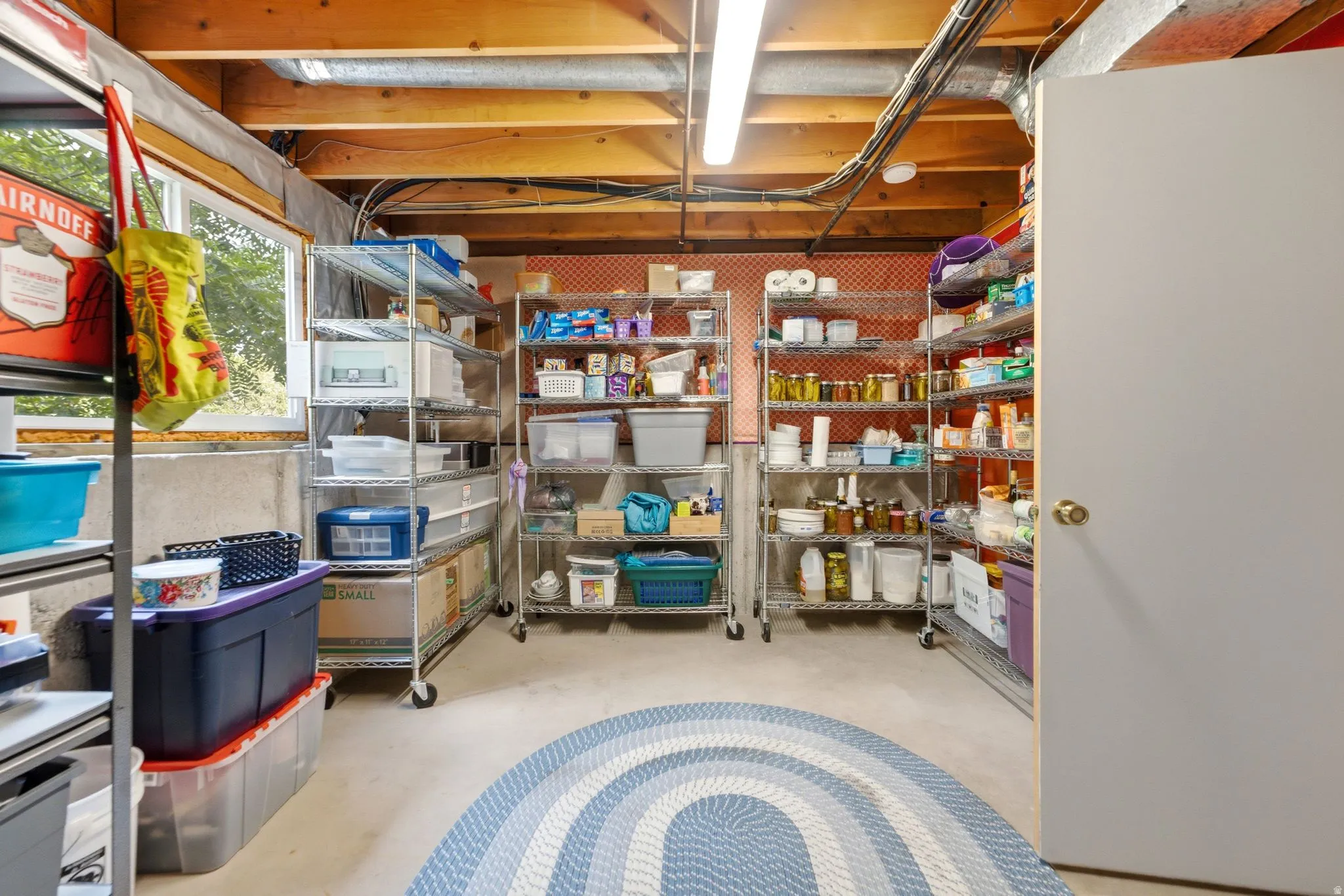 Utility room with exposed ceiling joists and a concrete floor