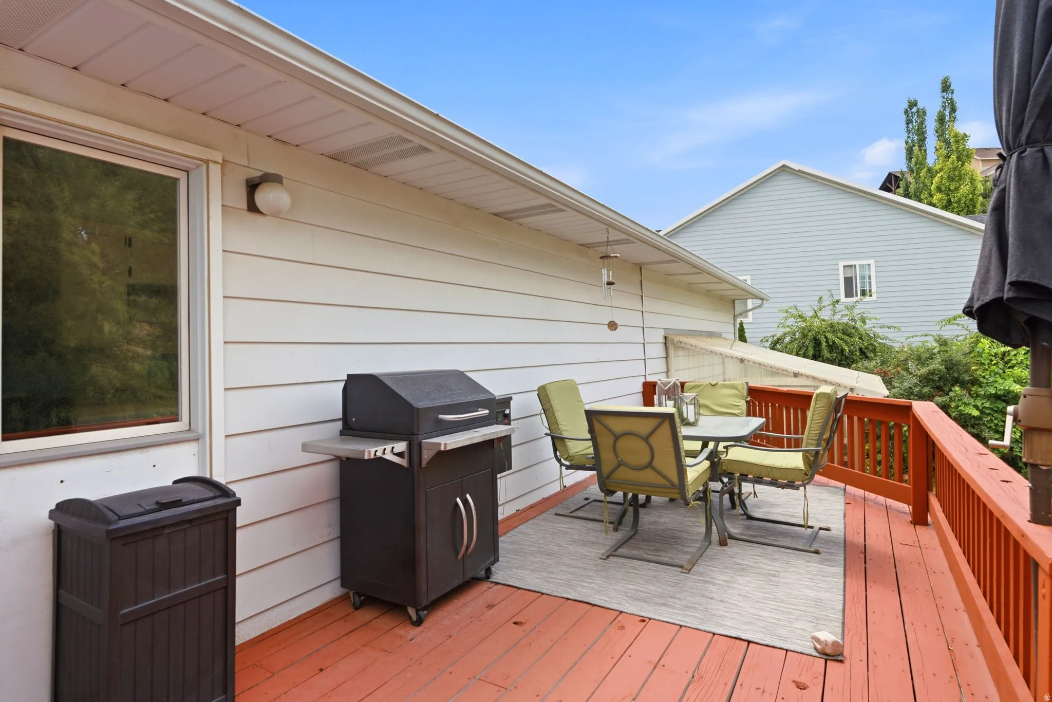 Wood deck with red-stained railings and flooring