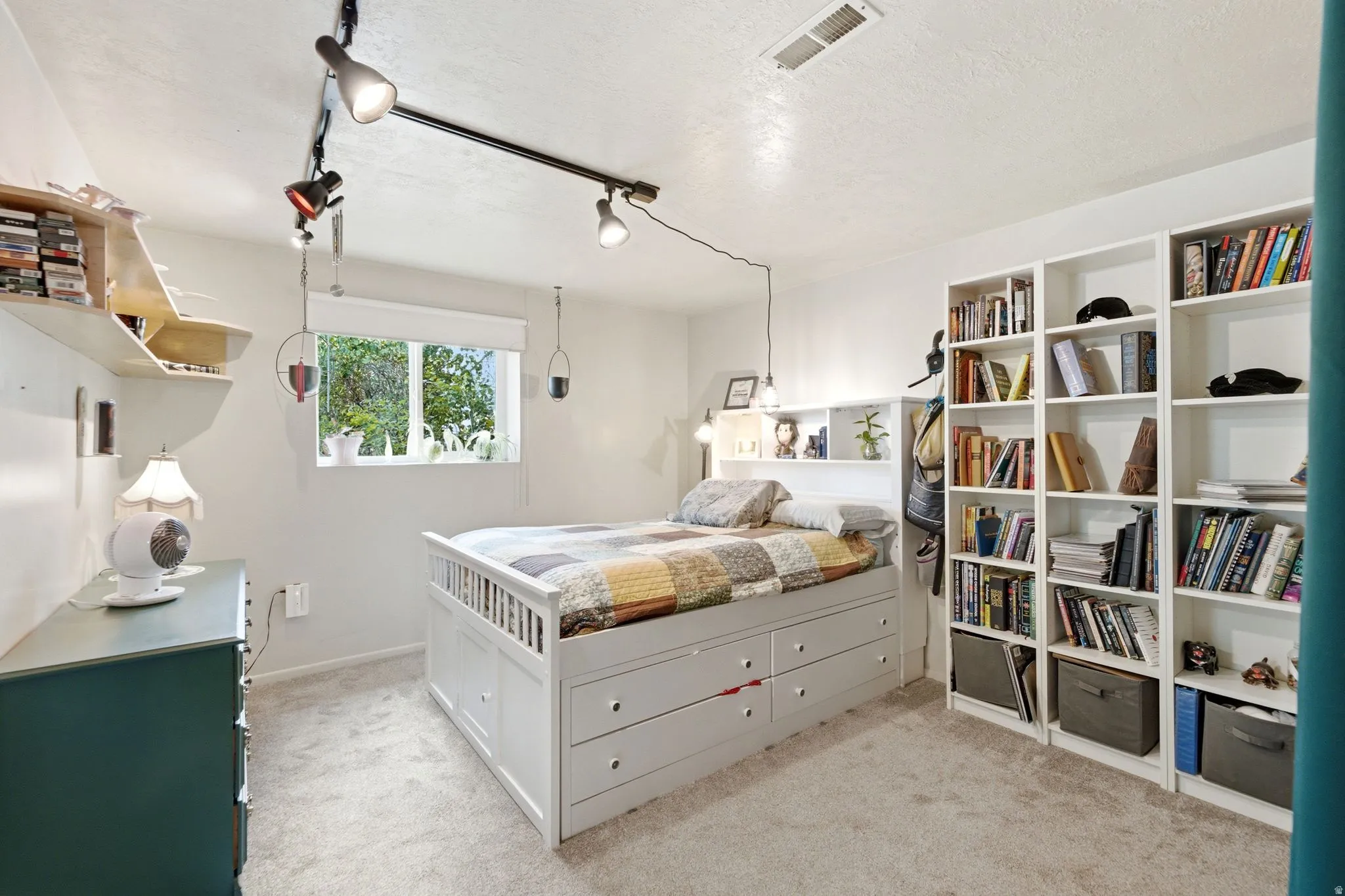 Light-colored wall-to-wall carpeting complements the white walls and trim