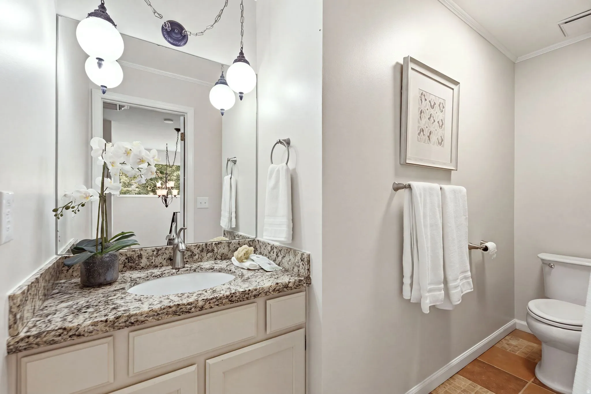 Vanity featuring an undermount sink, granite countertop, and light-toned cabinetry