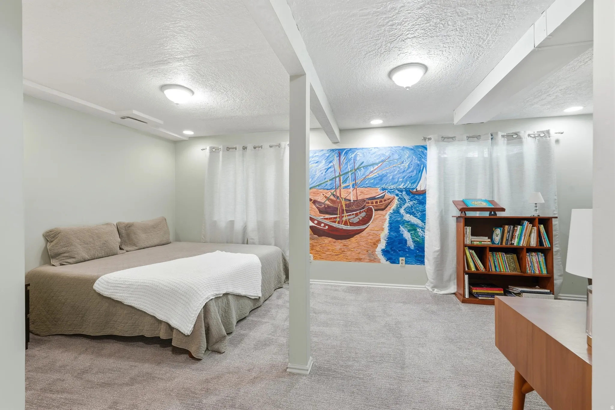 Carpeted room featuring exposed ceiling beams and recessed lighting