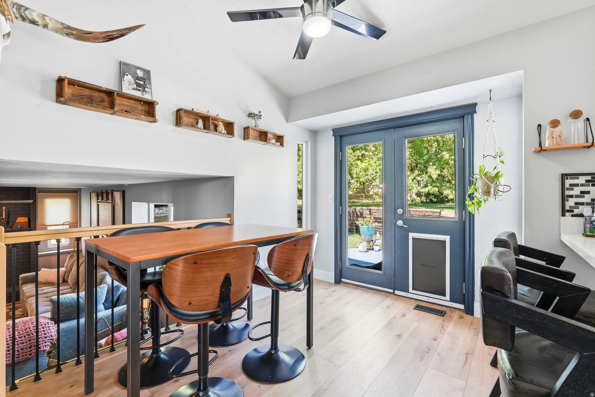 LVP flooring with bright double doors leading to outdoor space