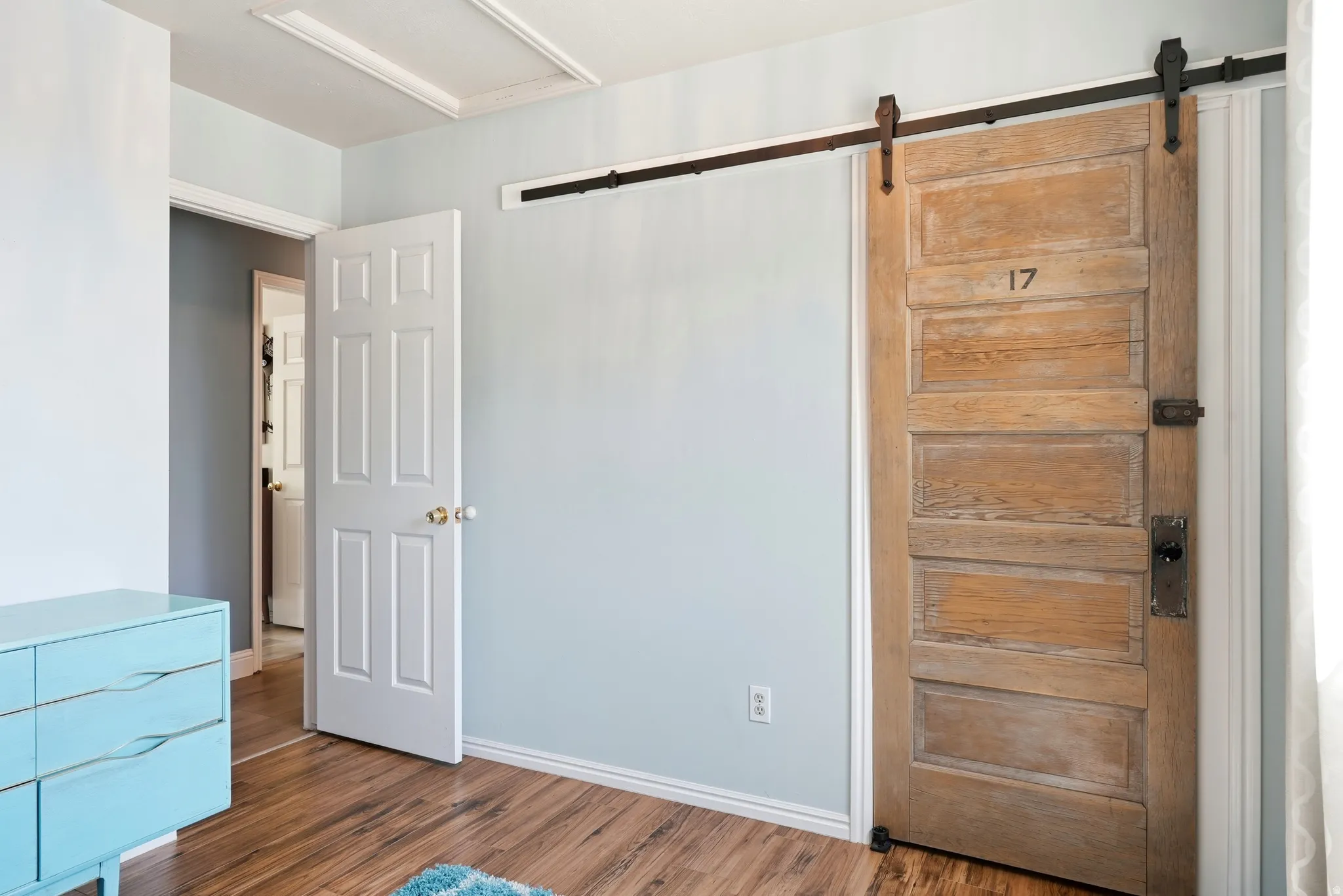 Reclaimed wood barn door with black iron hardware