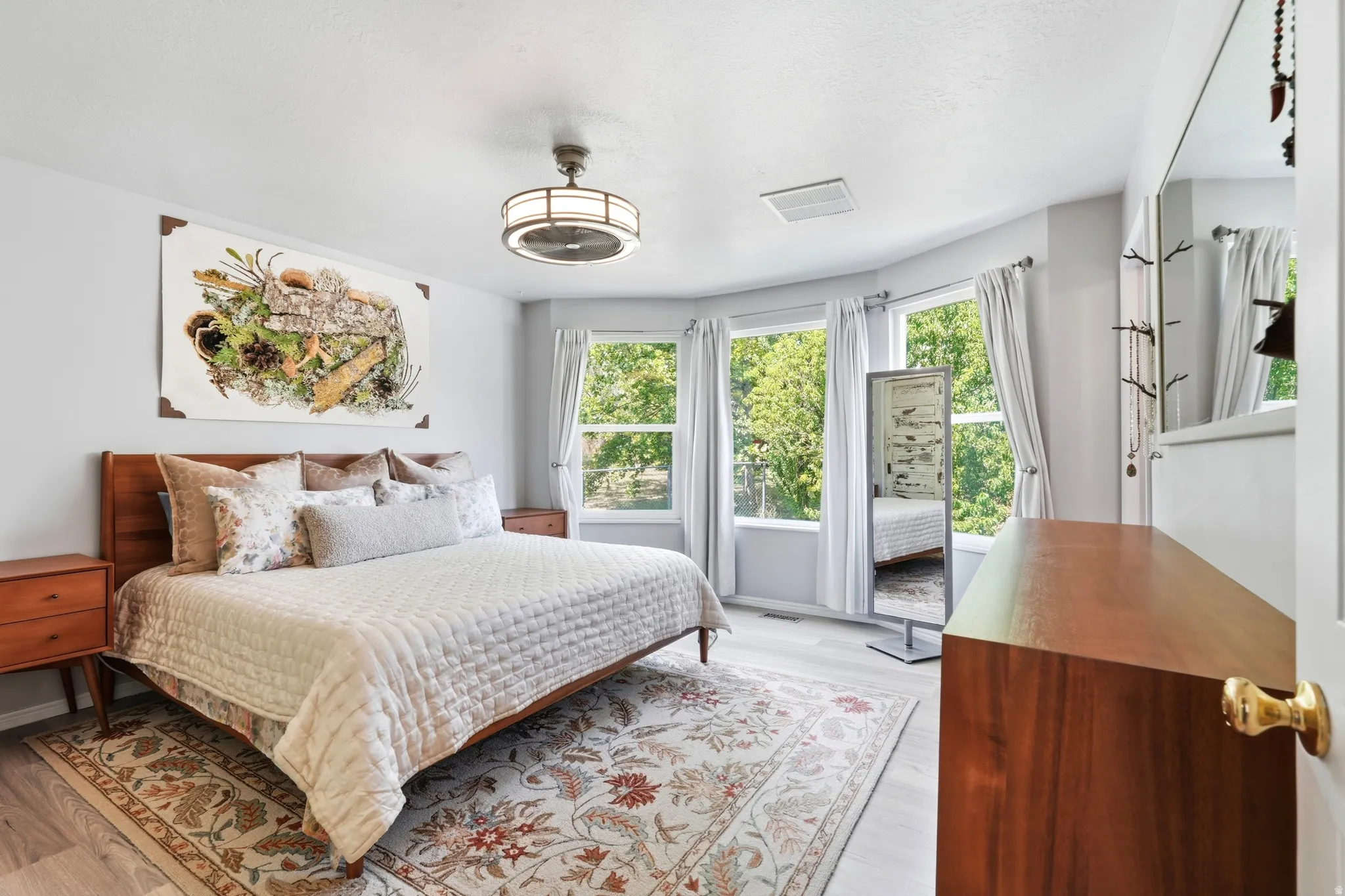 Primary Bedroom with bay windows, and walk in closet.