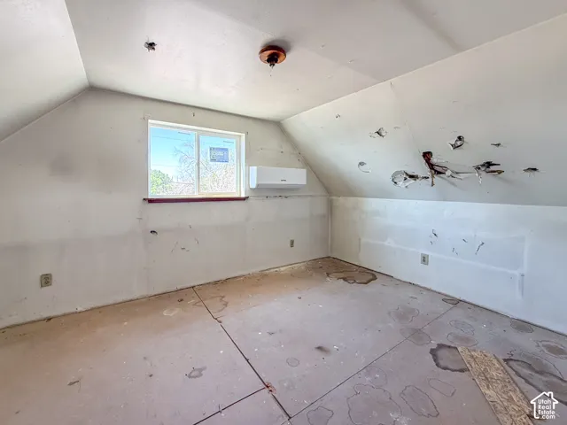 Interior space with sloped ceilings and a rectangular window