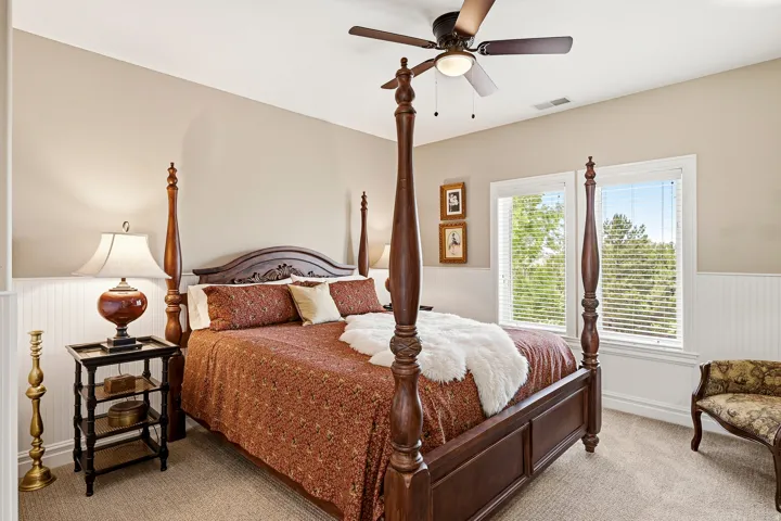 Bedroom 2 off the Loft with Private Bathroom, Ceiling Fan and Wainscoting Along the Walls, Overlooks the Front of the Home