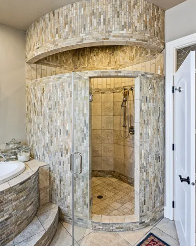 Curved Oversized Walk-In Shower with Glass Mosaic Tile, Dual Shower Heads, Private Sauna and a Built-in Shower Niche