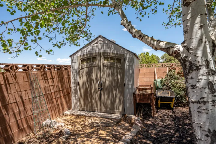 Convenient Freestanding Outdoor Storage Shed with Double Doors and Transom Windows