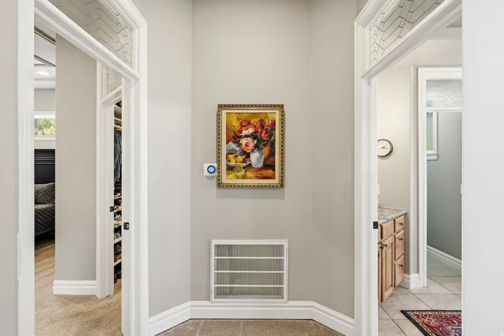 Elivated Entrance to the Private Primary Suite Featuring Arched Doorways with Decorative Transom Windows