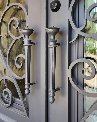 Beautifully Designed ron Front Door and Grand Entry with Ornate Iron Scrollwork and Textured Glass Panels