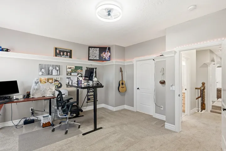 Bedroom 4 Overlooks the North East Side of the Home or Flexible Office/Creative Studio with Ceiling-Mounted Fan a Built-in Display Shelf, and White Trim