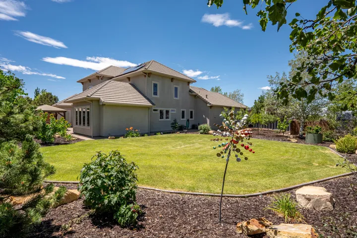 Private Backyard Framed by Mature Landscaping with Mulched Garden Beds and Room to Personalize