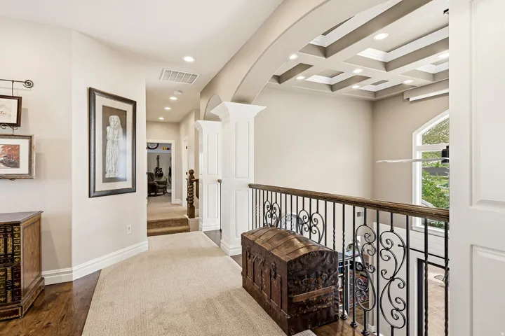 Upper-Level Open Loft Hallway with Architectural Views, Recessed Lighting, and a Coffered Ceiling