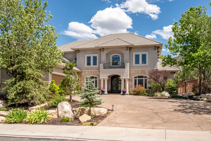 Custom Mediterranean-Inspired Estate with Stamped Concrete Driveway, Stucco Exterior with Stone Accents and a Tile Roof